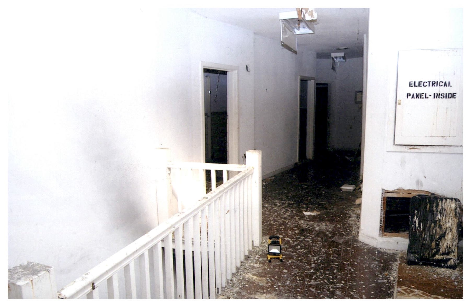 Before: same view of top floor hallway but with floor in disrepair.