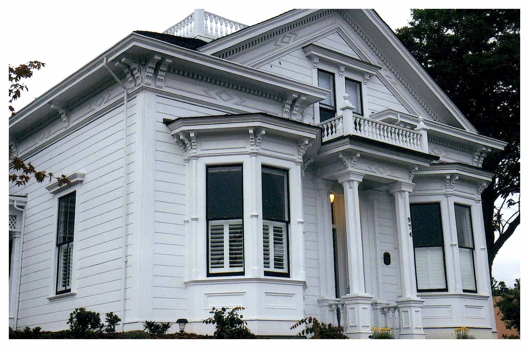 Front view of restored Italianate Chapman House painted white.