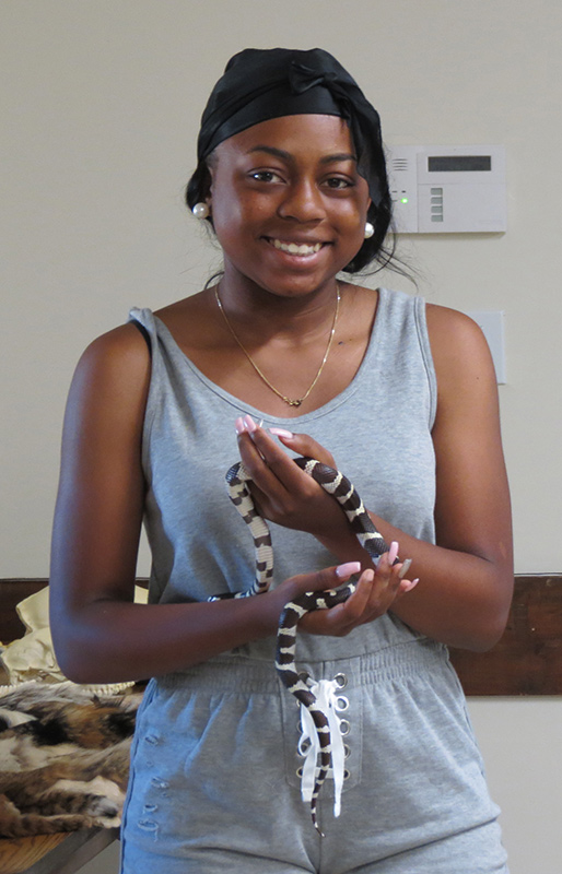 Program participant holding snake