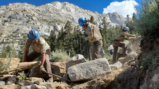 Youth corpsmembers building a hiking trail. 