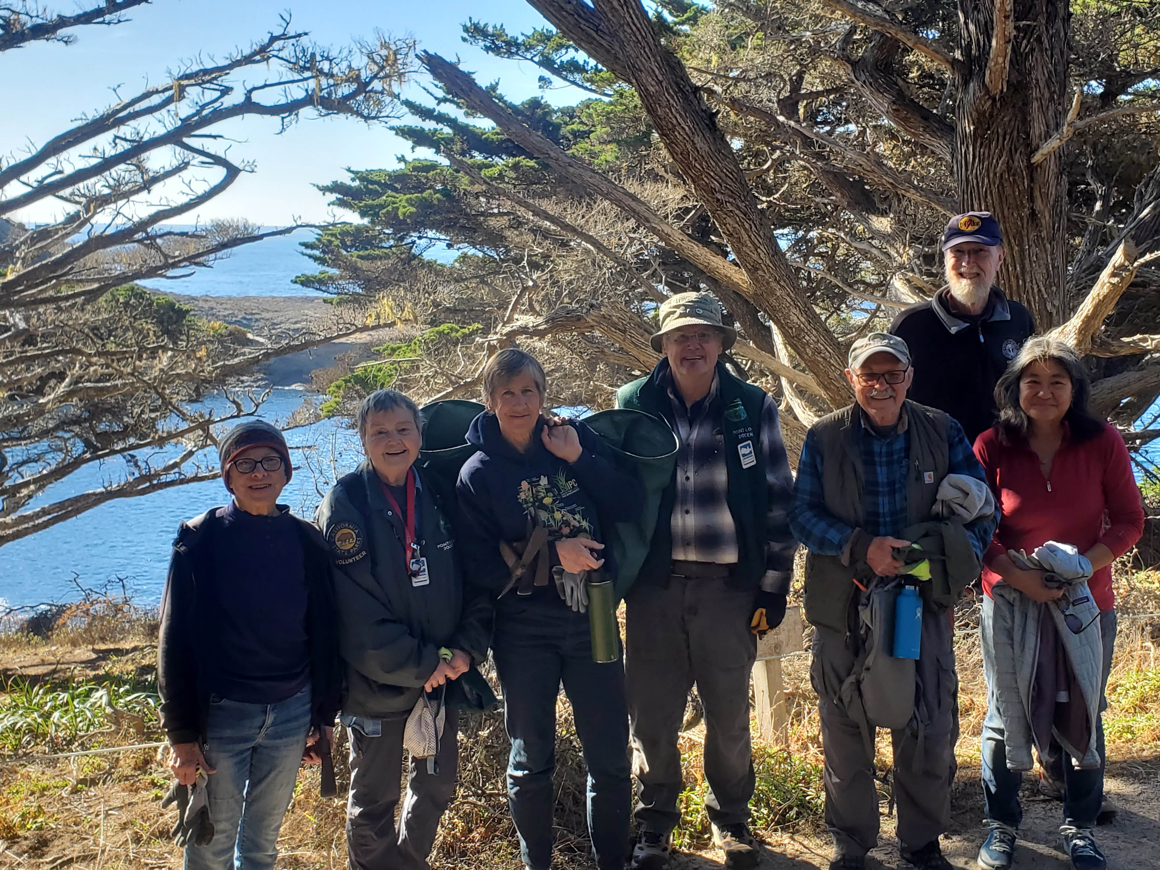 Volunteers pose after a morning of remove invasive grasses from the Cypress Grove at Point Lobos SNR.