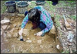 Patricia Petersen excavating unit near the location of the apothecary store.