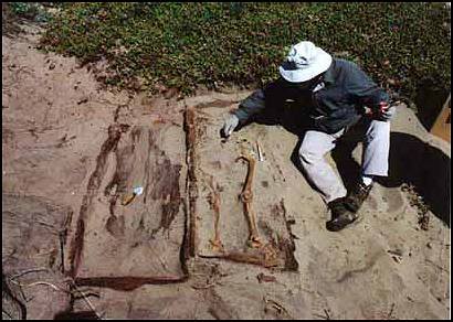 Peter Schulz next to exposed burial sites