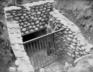 CCC crew member working on stone culvert in 1936
