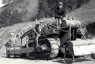 CCC crew member on road building tractor in 1935
