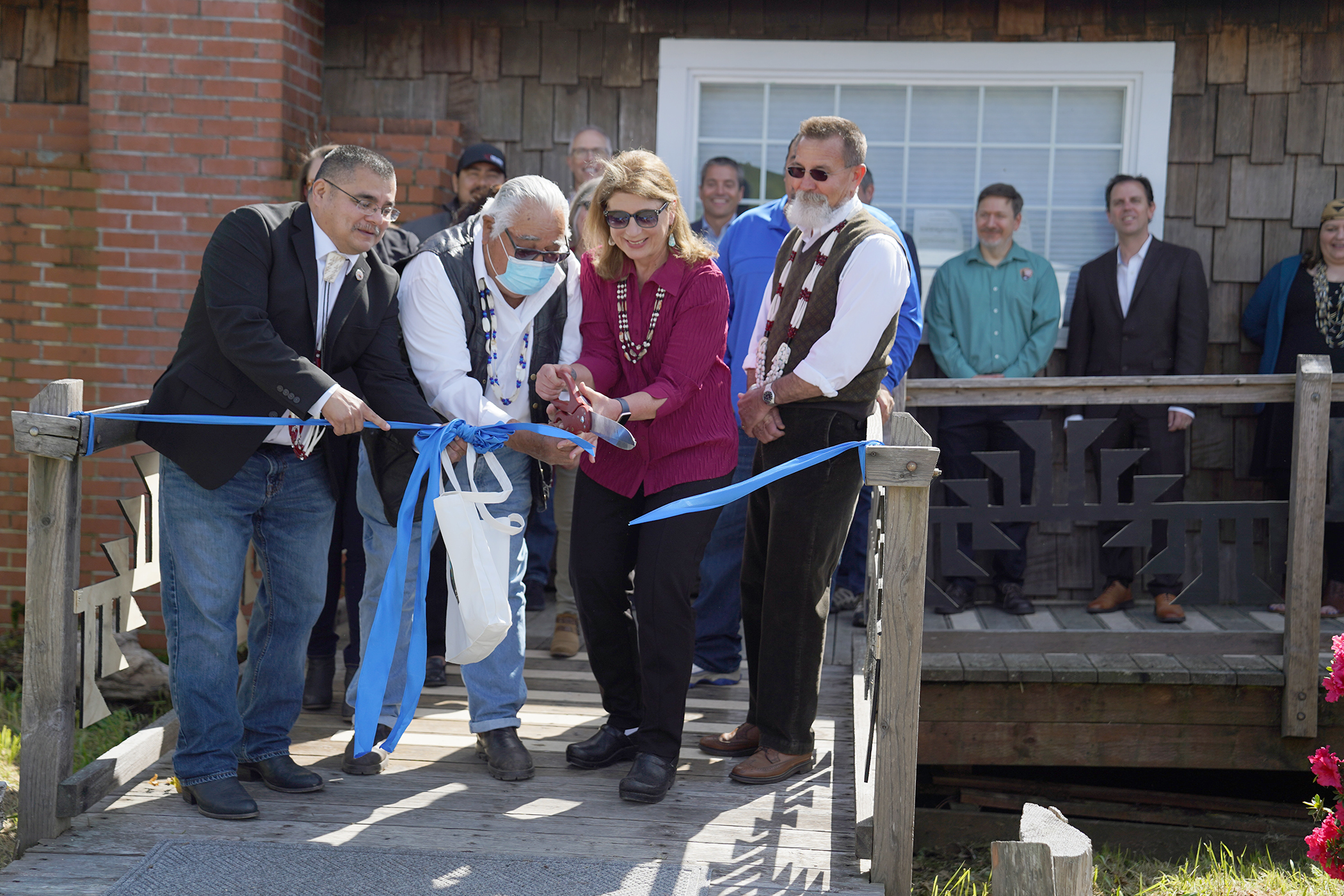 Representatives from the Yurok Tribe, California State Parks, and CA State Parks Foundation celebrate the grand opening of Chah-pekw Visitor Center 