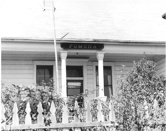 Historic photo of Pomona sign situated over the front door of the Call House