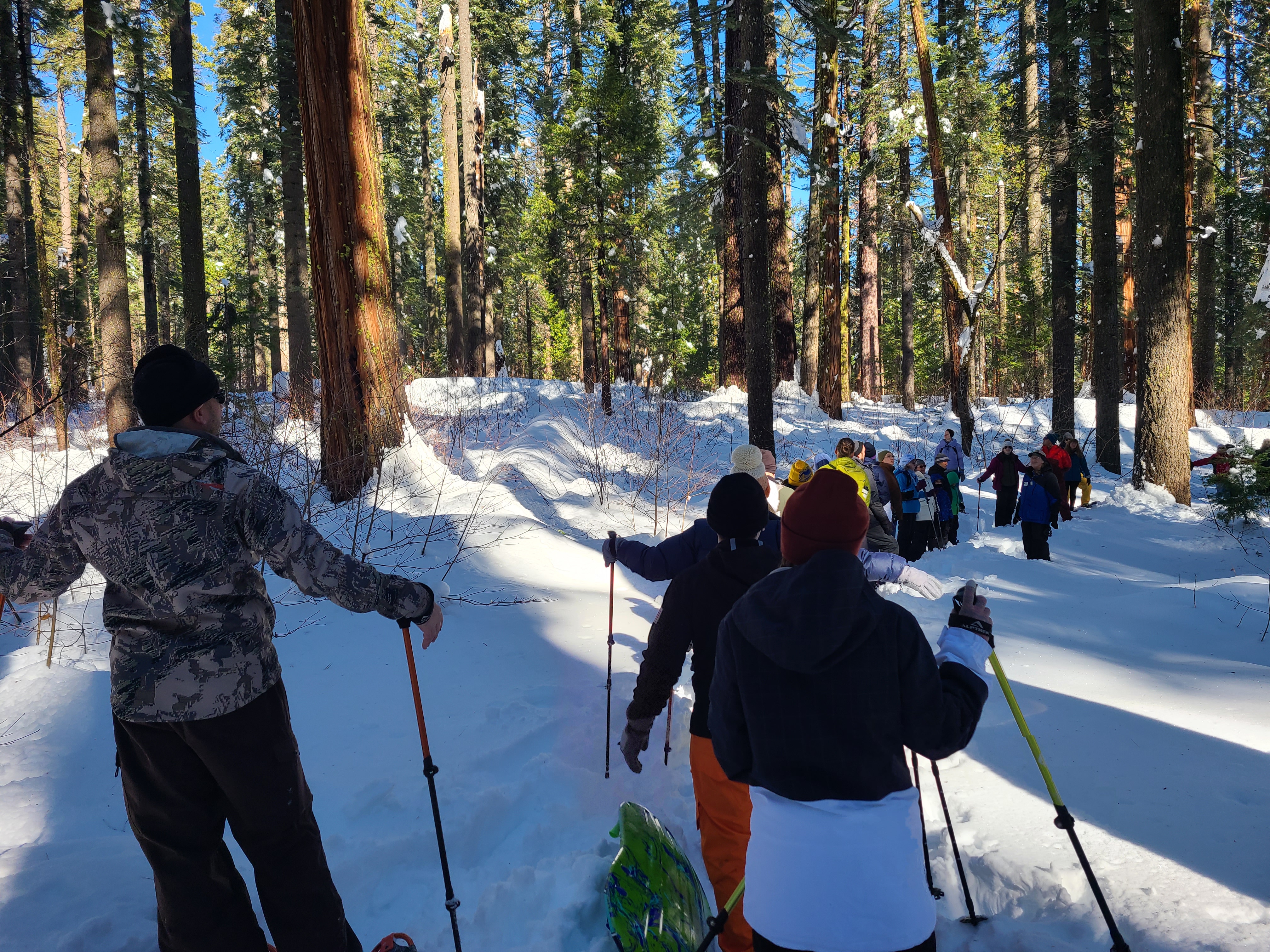 Visitors on Snowshoes Listening to a Volunteer Trail Guide
