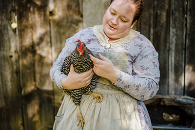 Volunteer holding a chicken