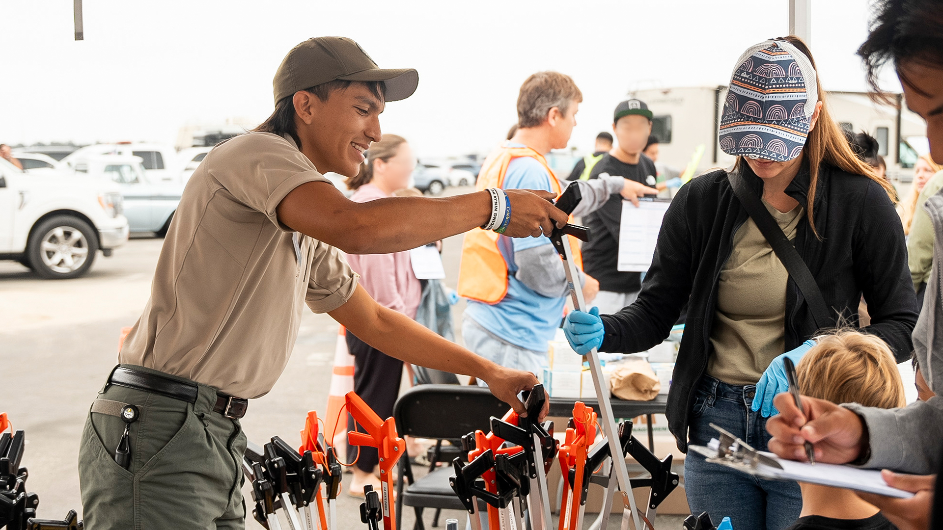Staff handing visitor a trash picker