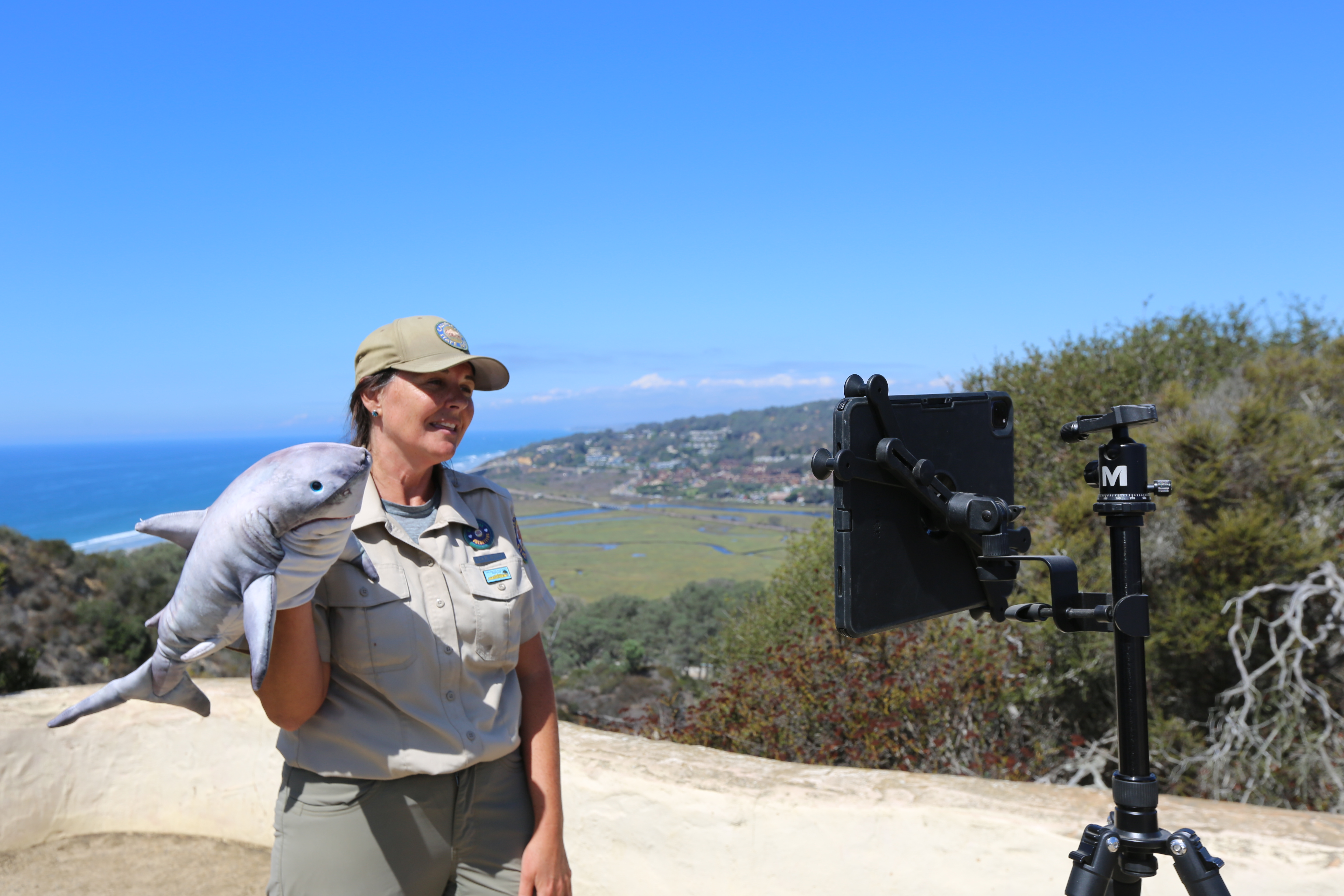 Interpreter sharing shark facts with students on our PORTSCast!