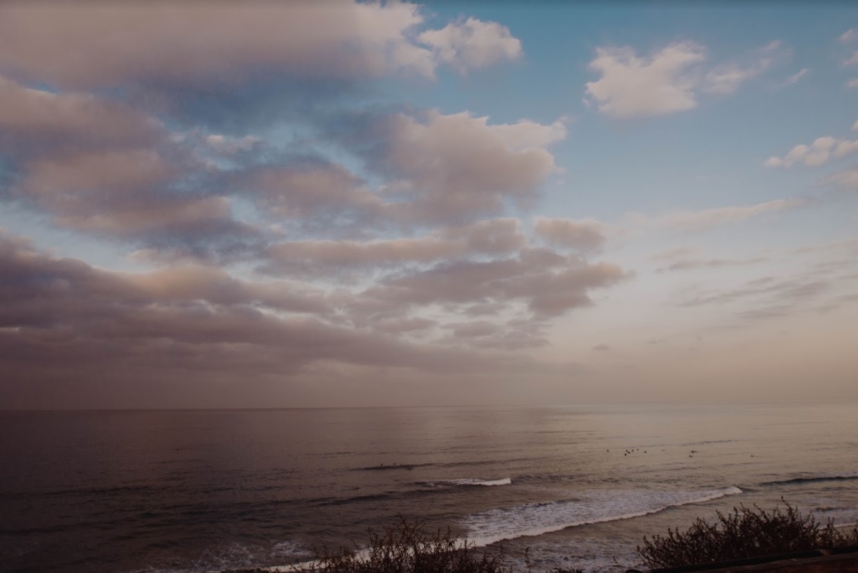 Photo of San Elijo State Beach looking toward the ocean with many clouds in the sky