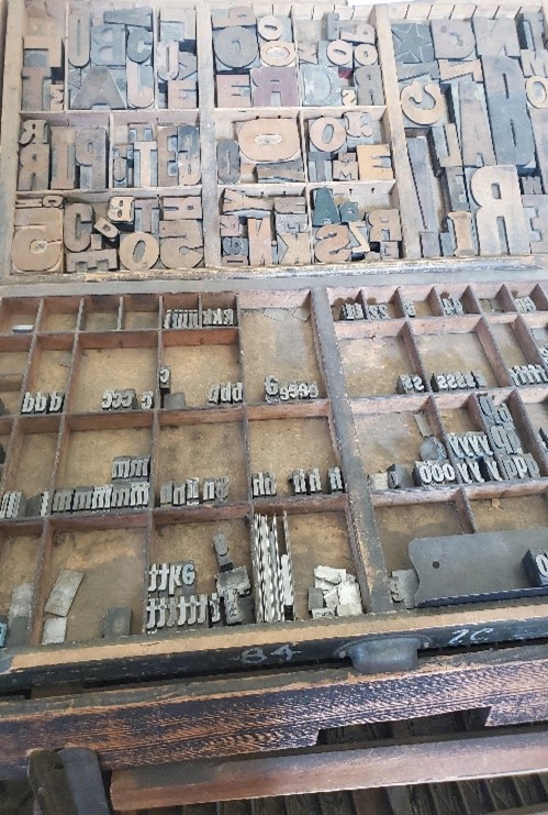 Photo of a type case with pieces of type in it