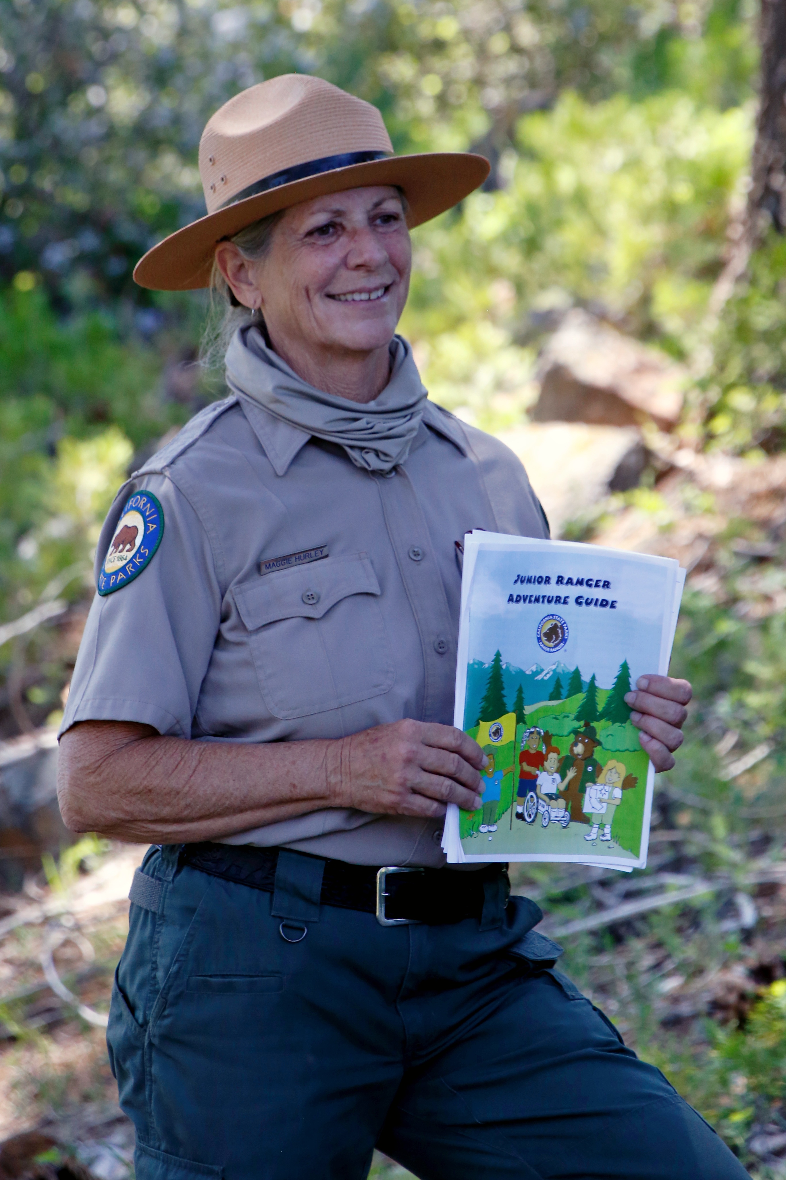 State Park Interpreter holding Junior Ranger Activity Guide