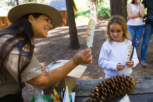 interpreter showing feathers to girl