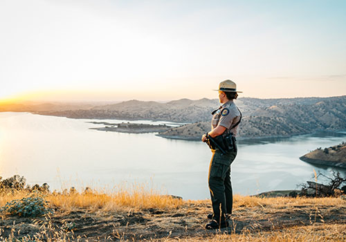 Ranger at Lake Millerton during sunset