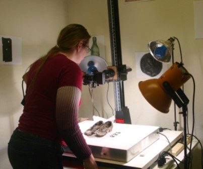 Student assistant Angela Avery taking photos of artifacts.